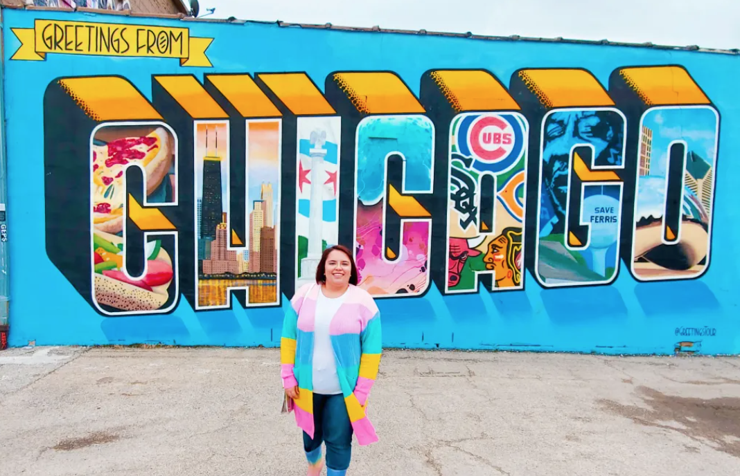 Person in front of Chicago mural